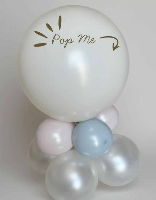 Balloon arrangement with a large white balloon labeled 'Pop Me' and smaller colored balloons below on a white background.